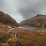 Located in the mountains of the Faroe Islands, Saksun feels like a place that time forgot. With its charming turf-roofed houses, a peaceful lagoon, and stunning views Located in the mountains of the Faroe Islands, Saksun feels like a place that time forgot. With its charming turf-roofed houses, a peaceful lagoon, and stunning views