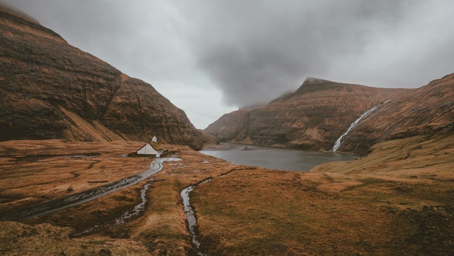 Located in the mountains of the Faroe Islands, Saksun feels like a place that time forgot. With its charming turf-roofed houses, a peaceful lagoon, and stunning views Located in the mountains of the Faroe Islands, Saksun feels like a place that time forgot. With its charming turf-roofed houses, a peaceful lagoon, and stunning views